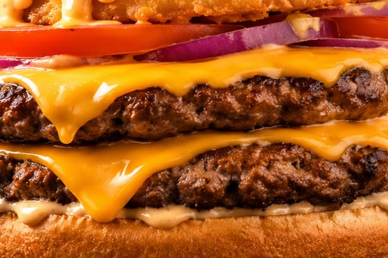 Gros plan sur le steak et le cheddar fondu d'un burger